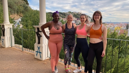 Tracy, Bibi, Kate and Ruby in exercise clothes, standing together in a park.