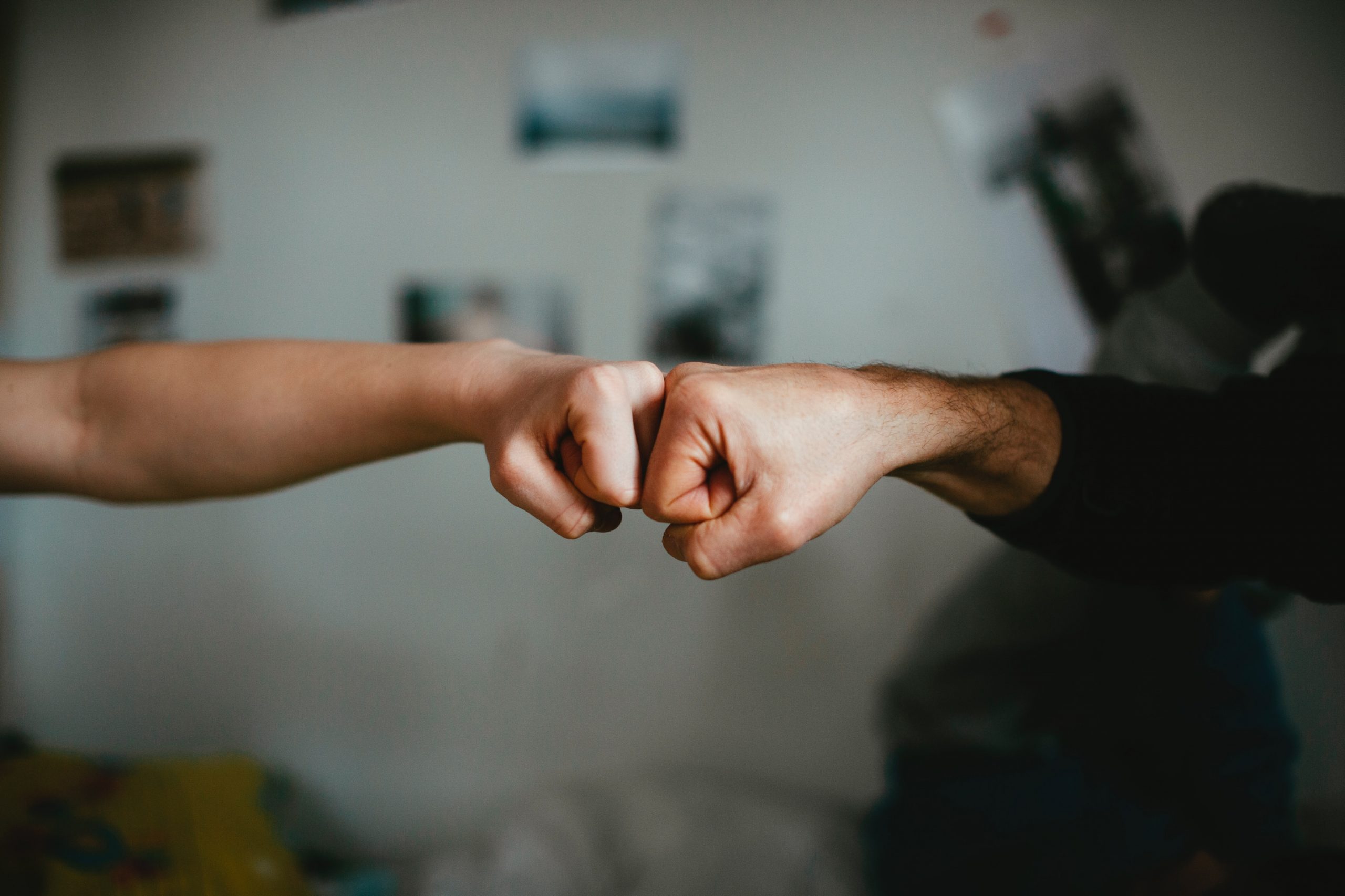 Two people fist-bumping.